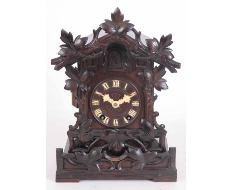 A 19th CENTURY BLACK FOREST DOUBLE FUSEE CUCKOO MANTLE CLOCK having carved leaf work case and 4" dial with applied bone numer