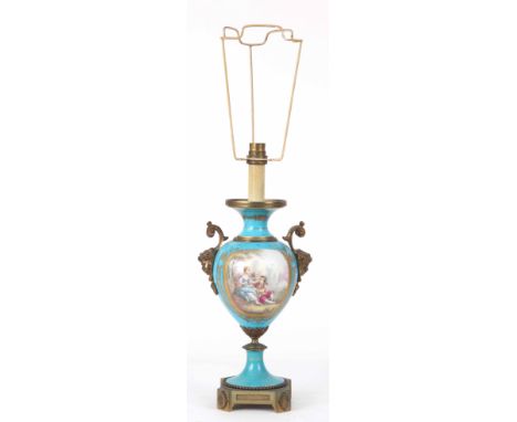 A SERVES STYLE LAMP with cherub mask handles decorated with romantic scenes 32cm high