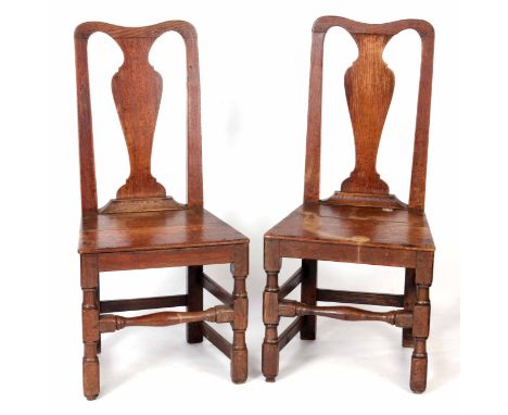 A PAIR OF LATE 17TH CENTURY OAK HALL CHIRS with vase-shaped splat backs, boarded seats and ring turned leg supports joined by