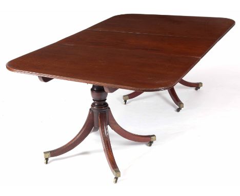 A GEORGE III MAHOGANY TWIN PILLAR DINING TABLE with centre leaf and rounded corners; standing on ring turned column base with