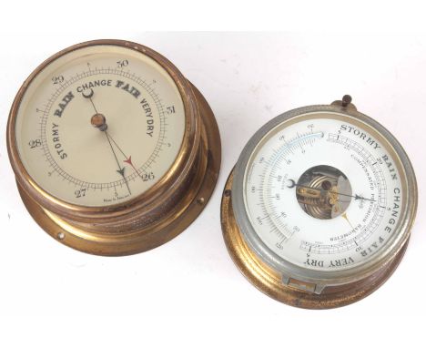 TWO BRASS CASED ANEROID SHIPS BAROMETERS one signed Schatz with thermometer 18 cm, the other 20.5 cm diameter.