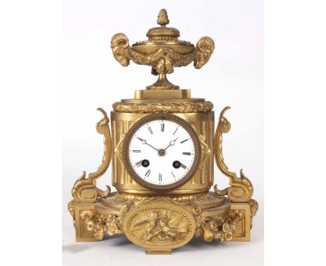 A LATE 19th CENTURY FRENCH ORMOLU MANTLE CLOCK the case surmounted by an urn with ram’s heads above oval shaped case with flo