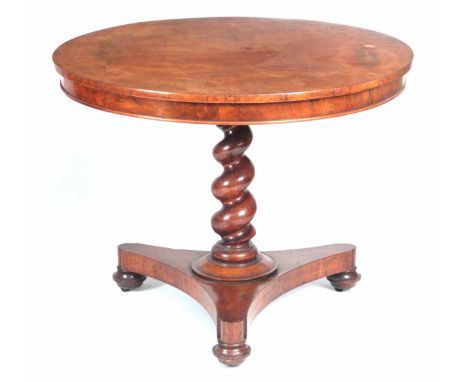 A MID 19TH CENTURY FIGURED WALNUT CIRCULAR TABLE OF SMALL SIZE with tilt top above a barley twist stem and tripod platform ba