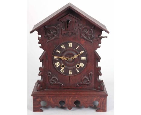 A LATE 19th CENTURY BLACK FOREST CUCKOO MANTLE CLOCK carved oak case with Roman numerals 48cm high 34cm wide