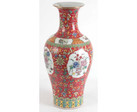 A LARGE CHINESE PORCELAIN VASE with flowers decorated on a red ground 87cm high.