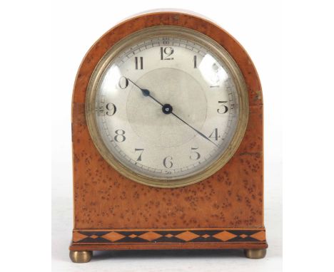 AN EARLY 20th CENTURY AMBOYNA CASED MANTLE CLOCK the arch case with diamond shaped inlay to the base, enclosing an engine tur