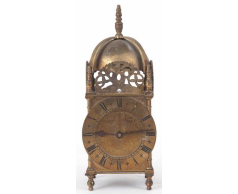 AN EARLY 20th CENTURY ENGLISH LANTERN STYLE MANTLE CLOCK of typical form with engraved brass dial fronting a spring driven ei