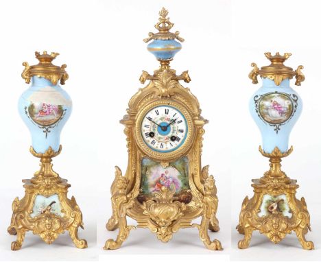 A LATE 19th CENTURY FRENCH GILT MANTEL CLOCK with urn finial and porcelain panel to the front depicting a romantic garden set