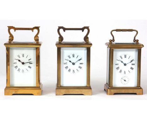 THREE EIGHT DAY BRASS CASED CARRIAGE CLOCKS all having spring driven movements with cylinder escapements and one with alarm f