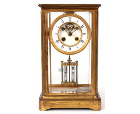 A LATE 19th CENTURY FRENCH FOUR GLASS MANTEL CLOCK the brass case framing four bevelled glass panels with hinged front and ba