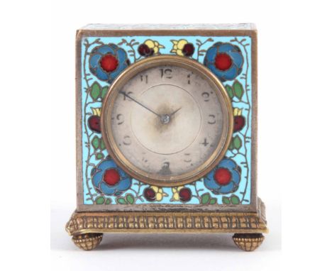 AN ENAMEL AND GILT TRAVEL CLOCK with silvered dial decorated with flowers 6.2cm