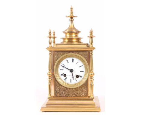 A 19th CENTURY FRENCH ORMOLU MANTLE CLOCK with engraved case surmounted by five finials enclosing enamel dial fronting spring