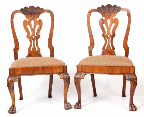 A PAIR OF GEORGE I STYLE WALNUT SIDE CHAIRS with carved vase-shaped splats, drop in seats and standing on carved cabriole leg