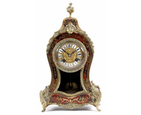 A LATE 19th CENTURY FRENCH BOULLE WORK BRASS AND TORTOISE SHELL INLAID MANTEL CLOCK the waisted case with torch finial and or