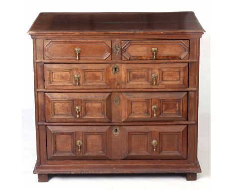 A LATE 17TH CENTURY OAK MOULDED FRONT CHEST OF DRAWERS with two-piece plank top above a bank of four graduated drawers with b