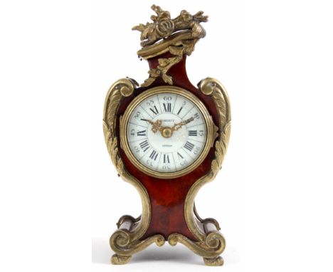 A FRENCH LATE 19th CENTURY RED TORTOISE SHELL AND ORMOLU MOUNTED MANTEL CLOCK RETAILED BY LIBERTY, LONDON, the serpentine cas