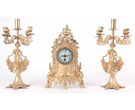 A LATE 19th CENTURY FRENCH GILT CLOCK GARNITURE with pierced gallery and urn finial enclosing a 3" floral painted porcelain d