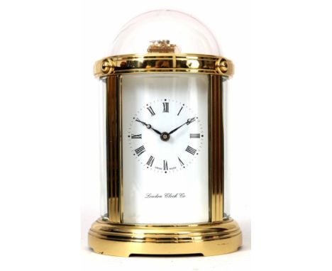 LONDON CLOCK COMPANY, A LATE 20th CENTURY SWISS MADE CARRIAGE CLOCK the brass circular case with curved bevelled glass panels