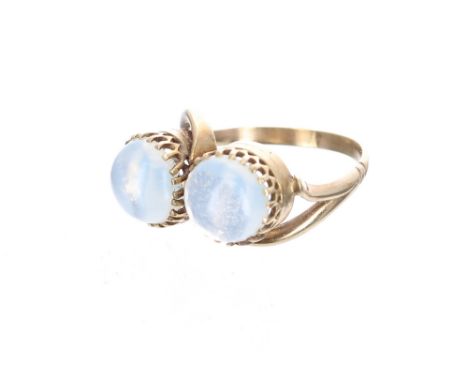 Yellow metal twist ring set with two cabouchon moonstones, each stone 9mm, 5.1gm, ring size Q/R, box