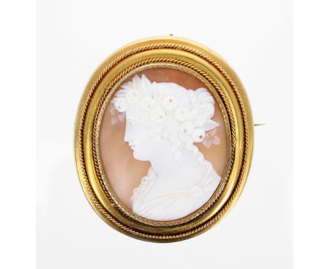 Victorian oval portrait cameo brooch, carved with a head and shoulders profile of a young Classical beauty in a yellow metal 