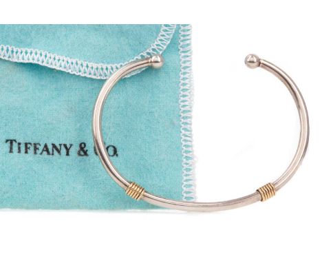 SILVER AND GOLD TORQUE BANGLE BY TIFFANY &amp; CO,with two eighteen carat gold sections, in pouch