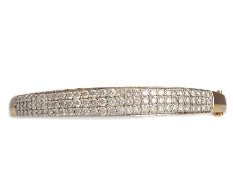 DIAMOND BANGLE,set with three rows of round brilliant cut diamonds totalling approximately 4.00 carats, marked 10K, 14.5g