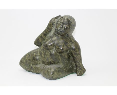 Inuit Carved Stone Nude Figure. Signed on base. Size: 9.5 11 x 6.5 in. Approx. Weight: 16 lbs