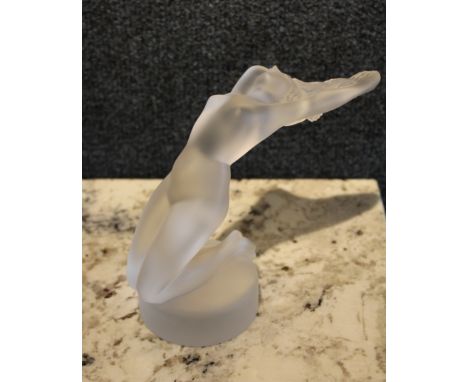 Signed 'Lalique France' on base. This Lalique female nude is made to appear swept up by the wind, with gracefully arched back