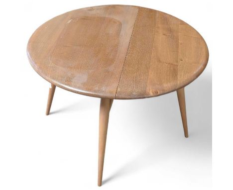An Ercol drop leaf coffee table upon three (extended to four) arm shaped feet, 40cm high, 60cm wide, 35.5cm deep