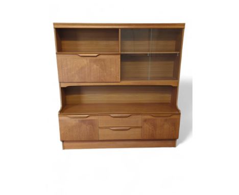 A mid-20th century G Plan style cabinet, to the top a fall front below a shelf and a sliding glazed door section, with an arr