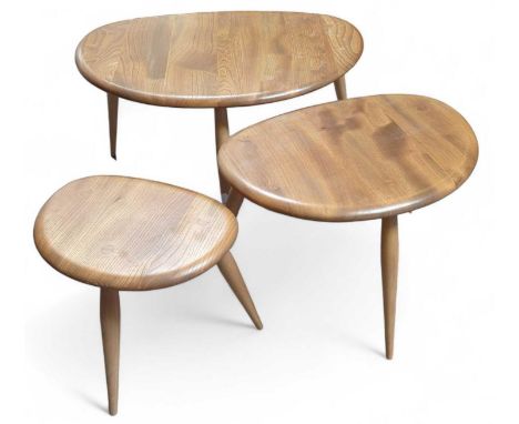 Three Ercol nested tables of round "D" shape and each with three arm-shaped legs. Blue sticker on smallest table's underside.