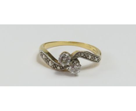 An early to mid-20th century old cut diamond two stone twist ring, diamond total weight approximately 0.12ct, with shaped bea