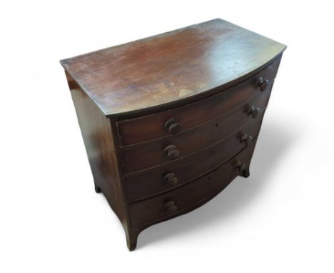 A 20th century oak bow fronted chest of four long drawers, increasing size gradient, upon bracket feet, 91.5cm high, 92.5cm w
