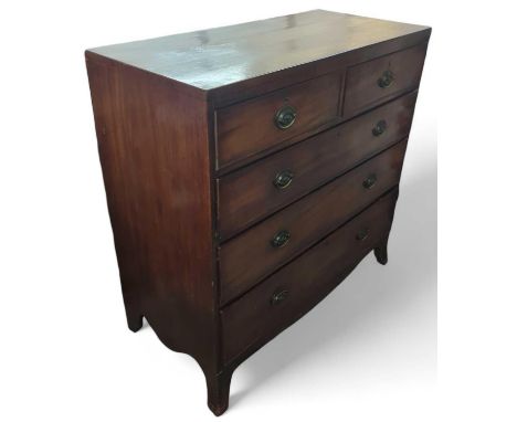 A 20th century mahogany chest of two short and three long drawers, with swing brass handles and curved bracket feet. Accompan