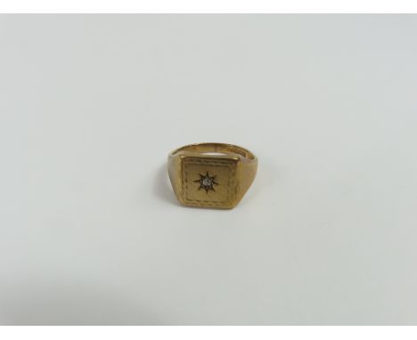 A 9ct gold signet ring, the square head with a patterned border and a star set old cut diamond to the centre, finger size Q l