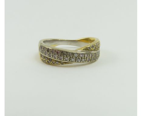 An 18ct yellow and white gold diamond set cross over band ring, finger size S centre, 9.2g gross