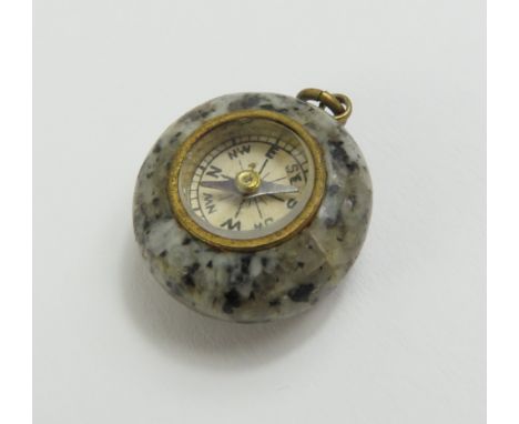 A miniature granite compass charm, 2.5cm long including hanging loop