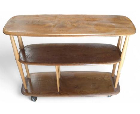 An Ercol bi-directional bookshelf of three shelves upon spherical wheels, 70cm high, 90cm wide, 32cm deep