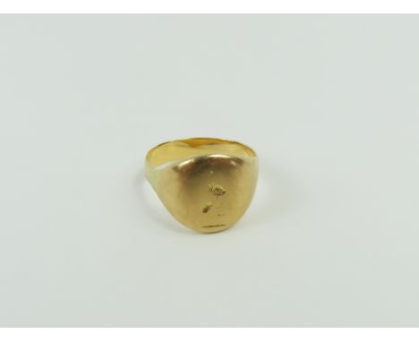 A signet ring, with very worn seal decoration, finger size Q centre, tests as approximately 18ct gold, 7.94g gross