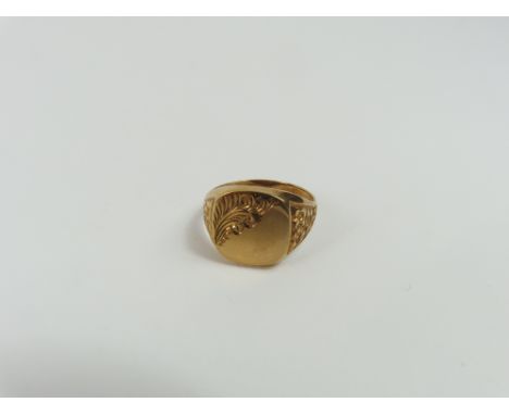 A 9ct gold signet ring, the square head half patterned and with floral decoration to the shoulders, finger size U, 3.66g gros