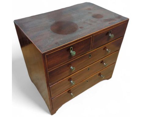 A 19th century mahogany veneer apprentice chest of two short and three long drawers, on four shaped bracket feet, 30.8cm high
