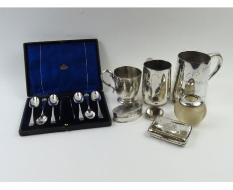 A small collection of silverwares, comprising a Victorian christening mug, cigarette case, silver mounted glass match striker
