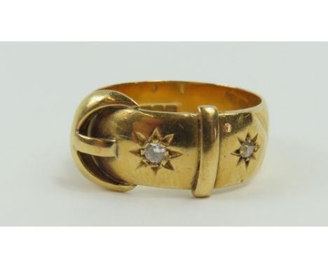 An 18ct gold buckle ring set with two old cut diamonds, finger size O 1/2 centre, 7g gross