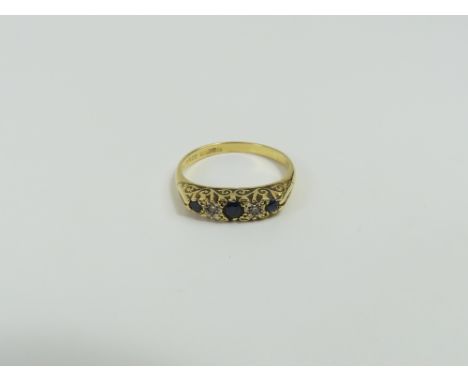 An 18ct gold sapphire and diamond carved head ring, finger size P 1/2, 4g gross