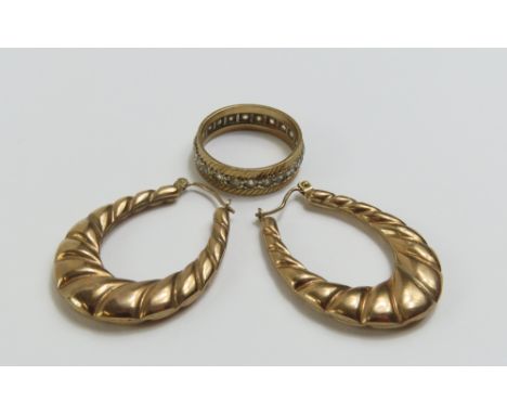 A pair of 9ct gold twisted hoop earrings, and a synthetic stone full eternity ring, marked '9ct', finger size M, 5.43g gross