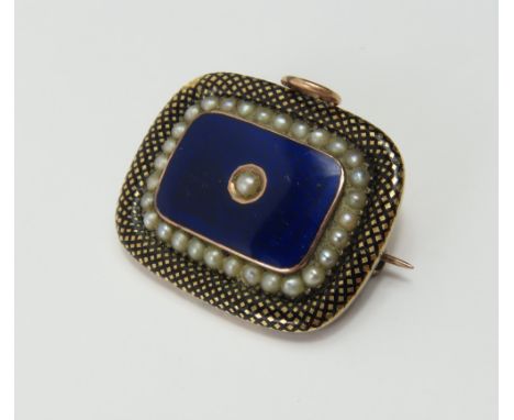 A 19th century mourning brooch, the rectangular shaped brooch with rounded corners, decorated with black and blue enamel and 