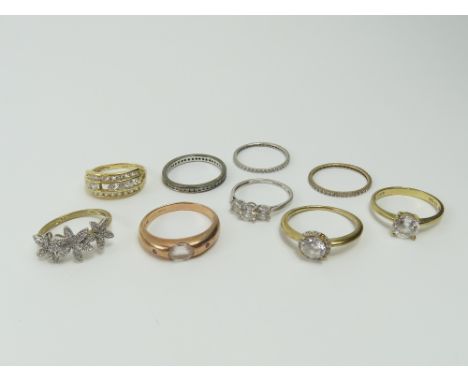 A 14ct gold white stone set dress ring, finger size N, 2.65g gross; a 9ct rose gold dress ring, with ruby accents, finger siz