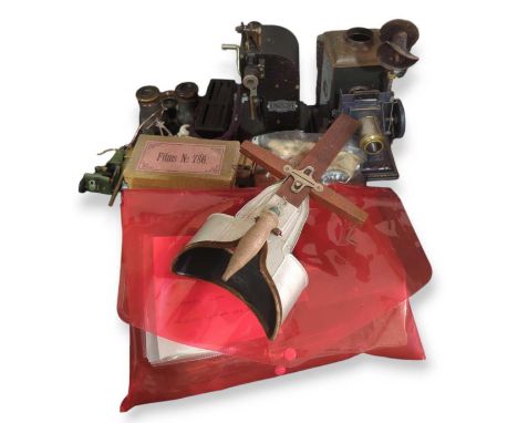 A hand held stereo viewer with a selection of stereo cards by Underwood & Underwood of the Boer War, a nursery magic lantern 