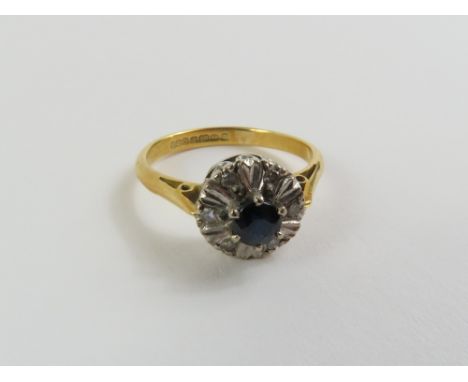 An 18ct gold sapphire and diamond cluster ring, finger size I, 2.52g gross, cased