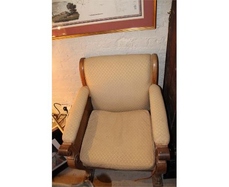 A 1920's walnut open armchair raised on mythical beast legs with swan head finial, purportedly made for the Crystal Palace ex